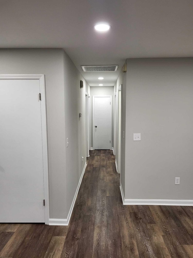 hallway with dark hardwood / wood-style flooring