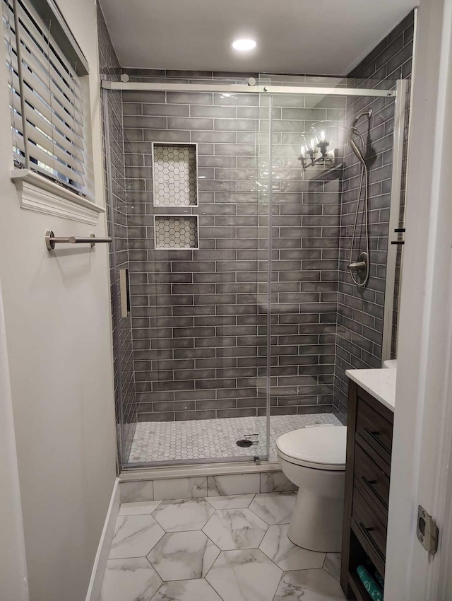 bathroom with vanity, an enclosed shower, and toilet