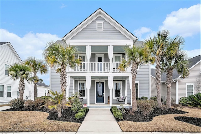 coastal home featuring a balcony and a porch