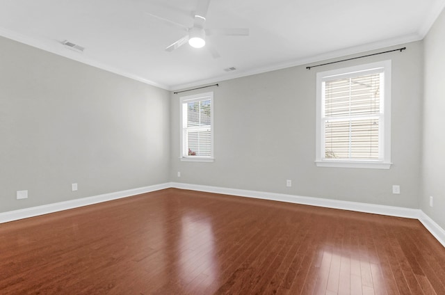 empty room featuring hardwood / wood-style floors, ceiling fan, a healthy amount of sunlight, and ornamental molding