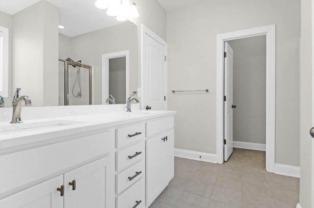 bathroom featuring tile patterned flooring, vanity, and a shower with door