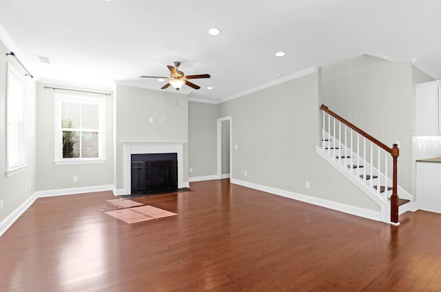 unfurnished living room with dark hardwood / wood-style flooring, ceiling fan, and crown molding