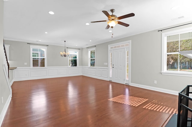 interior space featuring crown molding, hardwood / wood-style floors, a healthy amount of sunlight, and ceiling fan with notable chandelier