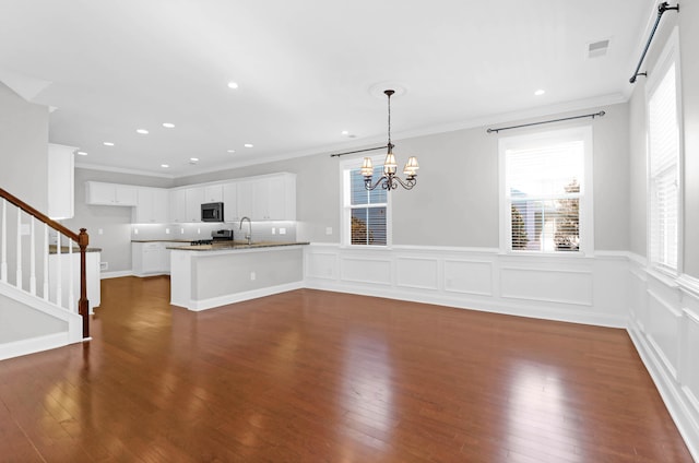 interior space with sink, crown molding, dark wood-type flooring, and a chandelier