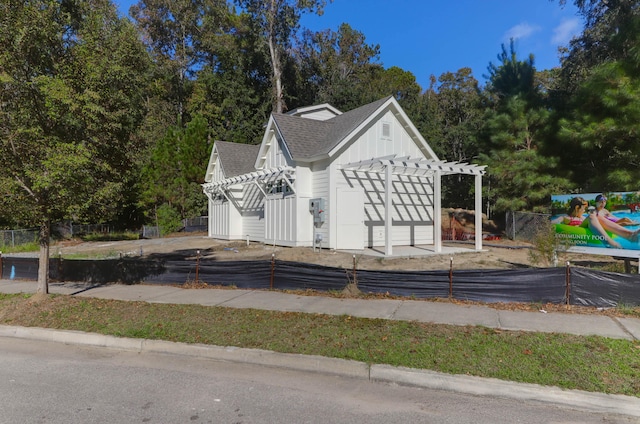 view of side of property with a pergola