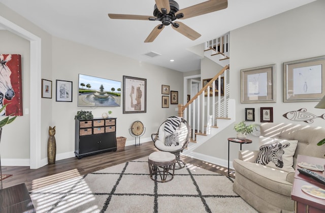 living room with dark hardwood / wood-style floors and ceiling fan