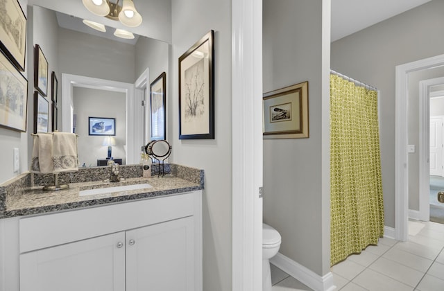 bathroom featuring vanity, tile patterned floors, and toilet