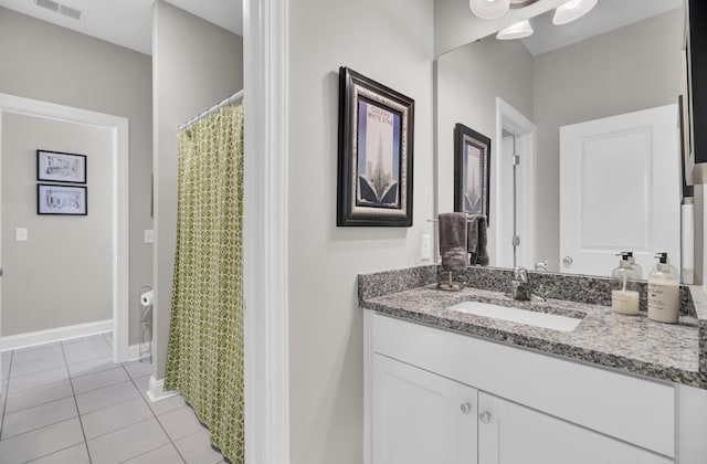 bathroom featuring tile patterned flooring and vanity