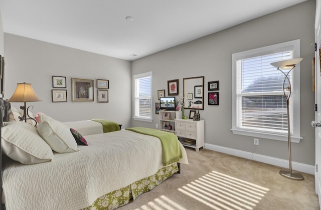 bedroom featuring light carpet