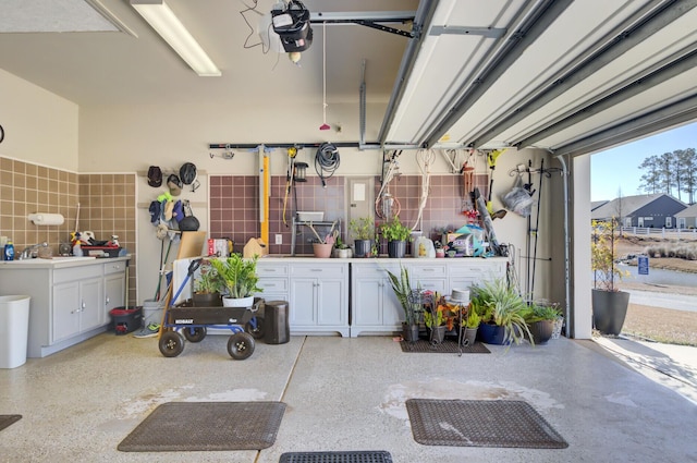 garage featuring a garage door opener and sink