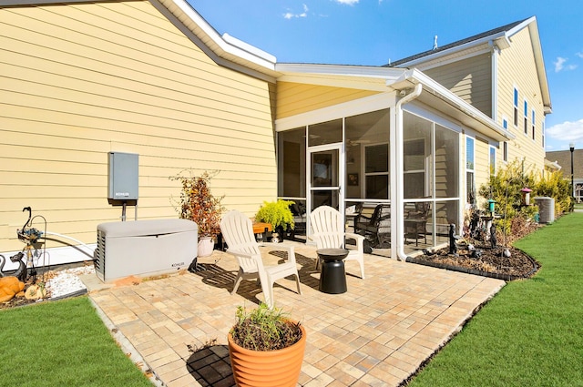 back of house with cooling unit, a yard, a patio area, and a sunroom