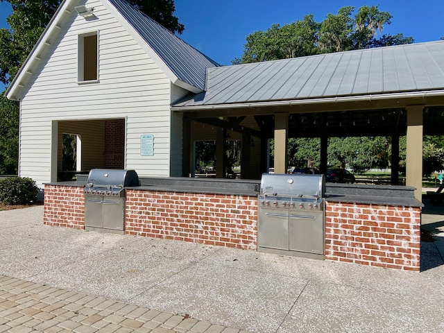 view of front of property with a gazebo and an outdoor kitchen