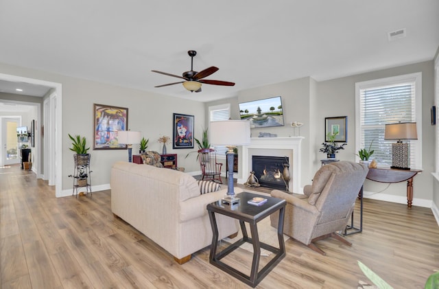 living room featuring ceiling fan and light wood-type flooring