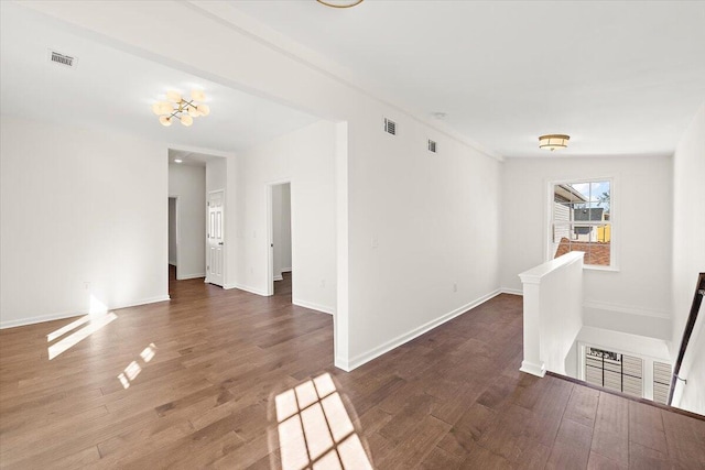 empty room with visible vents and wood finished floors
