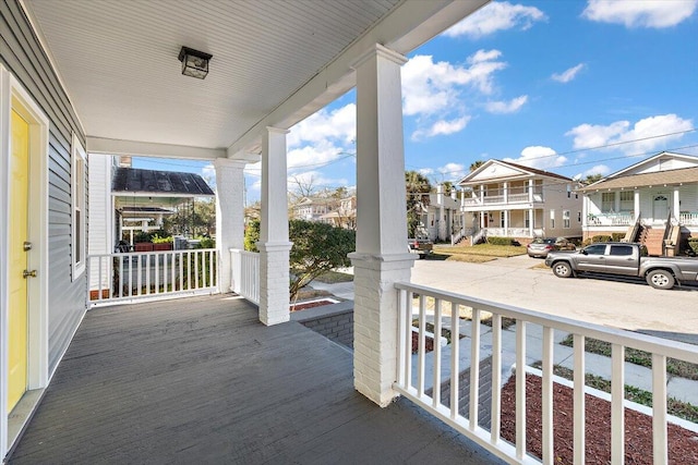 balcony with covered porch and a residential view