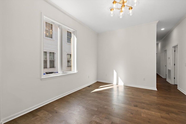 spare room with crown molding, baseboards, dark wood-style floors, and a notable chandelier
