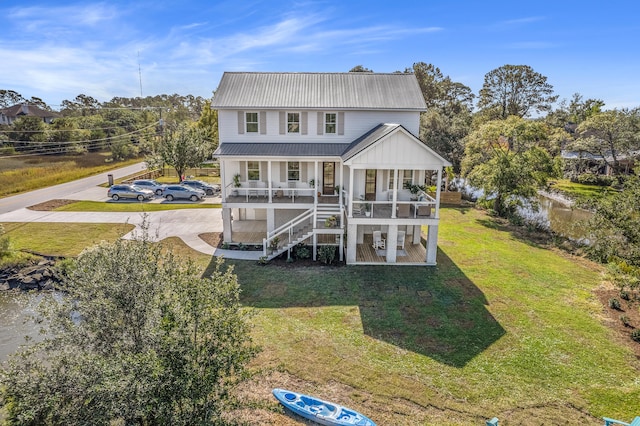 back of property featuring a yard and a porch