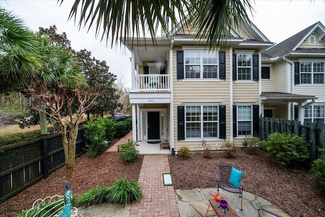 back of house featuring a balcony