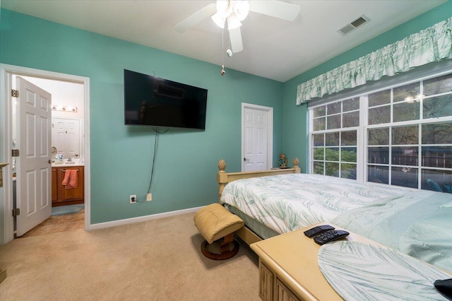 carpeted bedroom featuring ensuite bathroom and ceiling fan