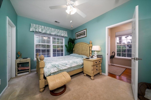 bedroom featuring a closet, ceiling fan, carpet floors, and multiple windows