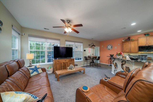 living room with carpet floors and ceiling fan