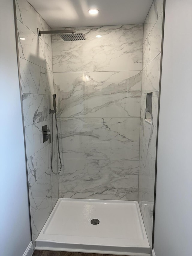 bathroom with a marble finish shower