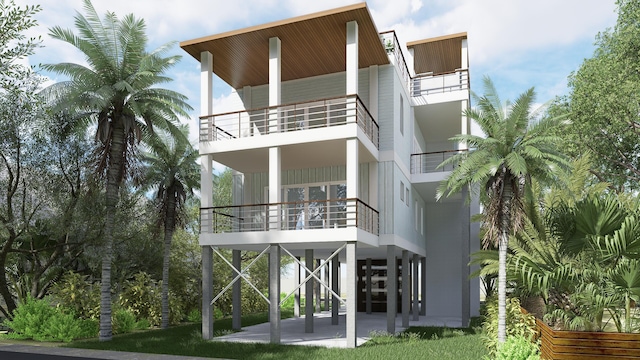 rear view of house with stairway and a patio