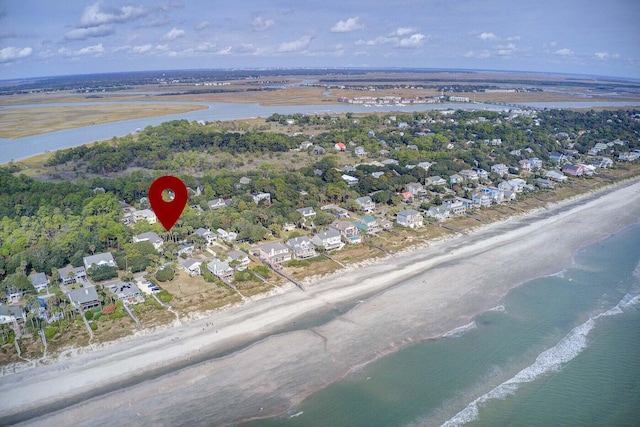 birds eye view of property with a water view and a view of the beach