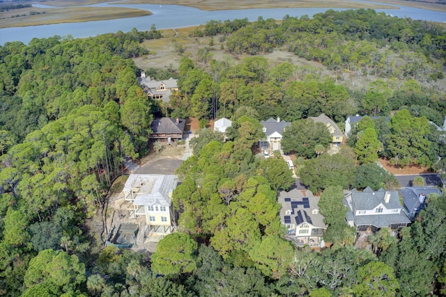 birds eye view of property featuring a forest view, a residential view, and a water view