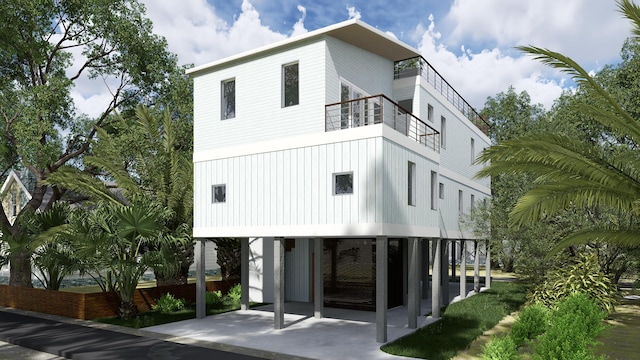 rear view of house with a carport and a balcony