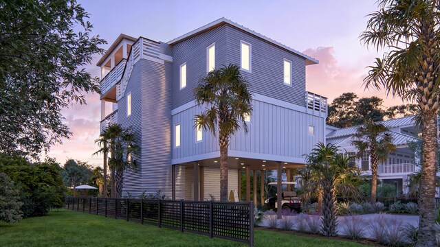exterior space with fence and a lawn