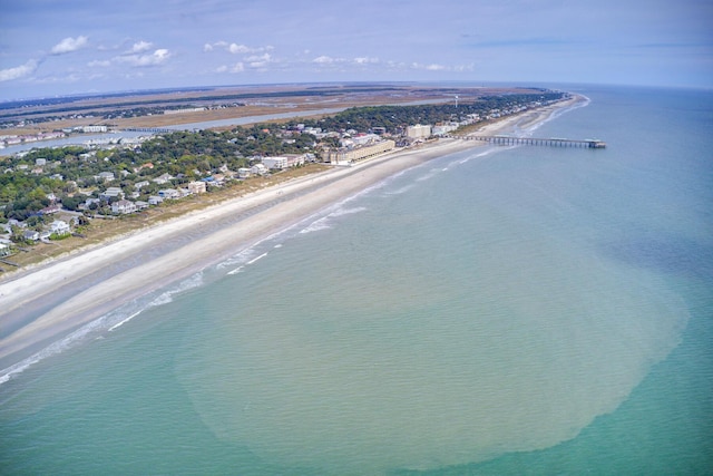 drone / aerial view with a water view and a beach view