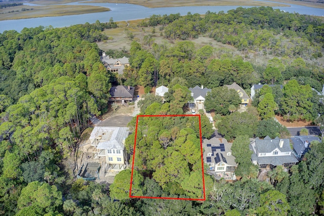 birds eye view of property featuring a residential view, a water view, and a view of trees