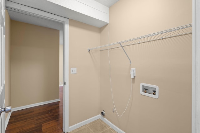 laundry room with washer hookup, laundry area, wood finished floors, and baseboards