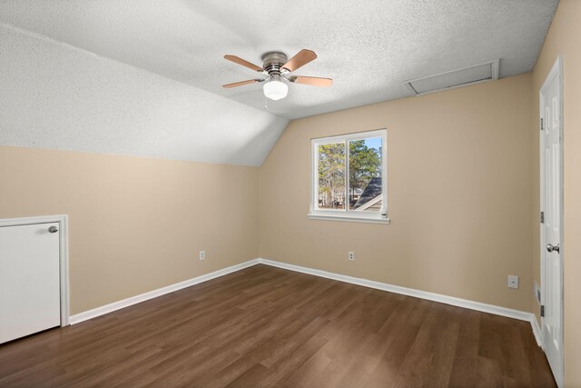 bonus room featuring baseboards, attic access, lofted ceiling, wood finished floors, and a textured ceiling