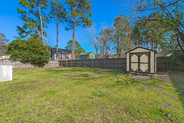 view of yard featuring a storage shed, a fenced backyard, and an outdoor structure