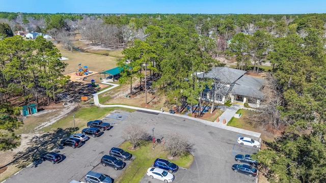 birds eye view of property featuring a view of trees