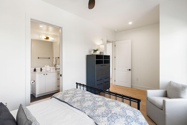 bedroom featuring baseboards, recessed lighting, light wood-style flooring, ensuite bathroom, and ceiling fan