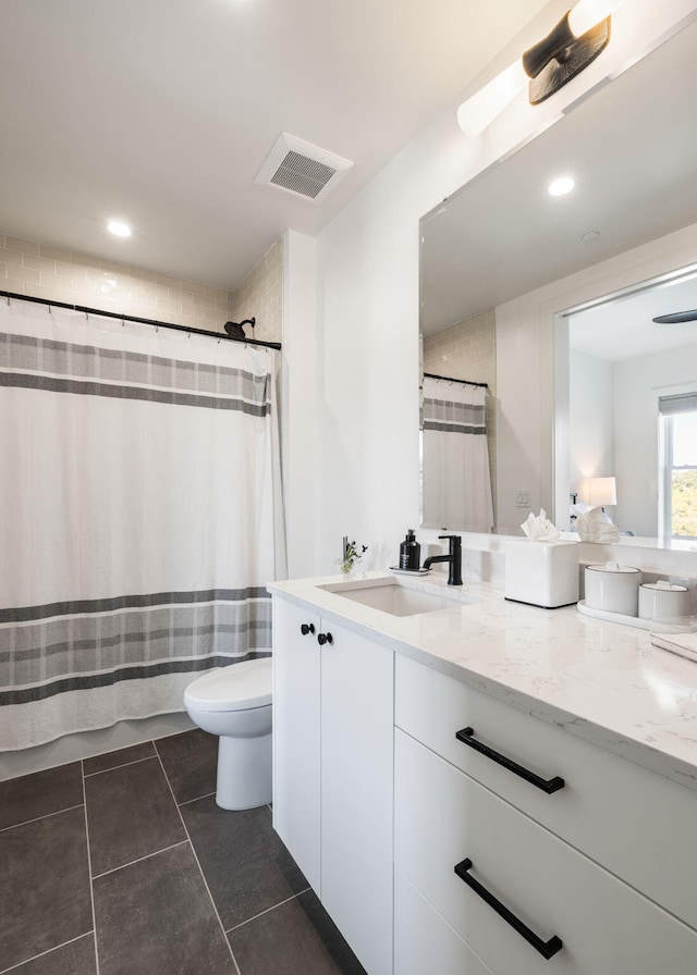 bathroom featuring vanity, visible vents, toilet, a shower with shower curtain, and tile patterned floors