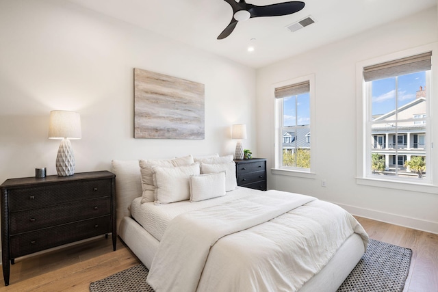 bedroom with light wood-type flooring, baseboards, recessed lighting, visible vents, and ceiling fan