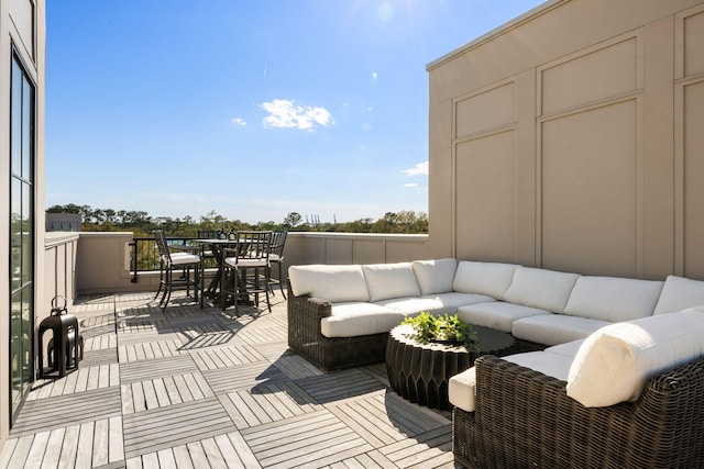deck featuring outdoor dining area and outdoor lounge area