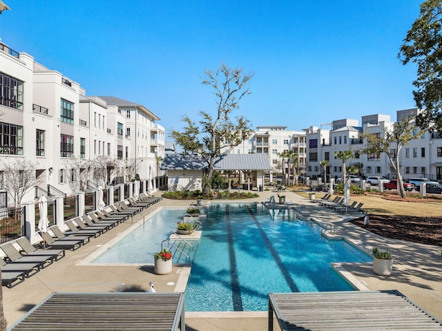 pool with a residential view and a patio