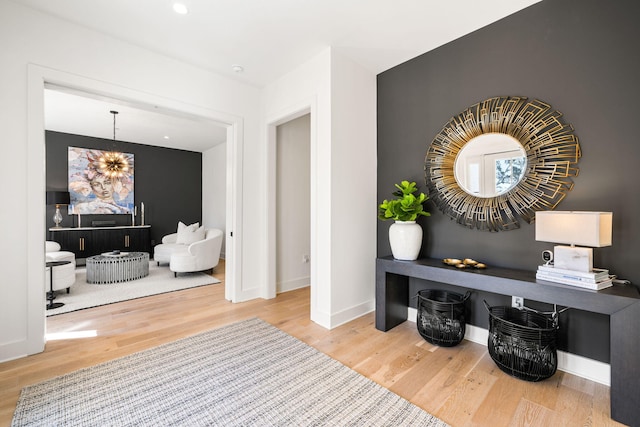 interior space with baseboards, an inviting chandelier, and wood finished floors