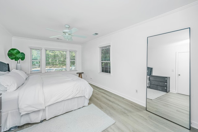 bedroom with ceiling fan, light hardwood / wood-style flooring, and crown molding