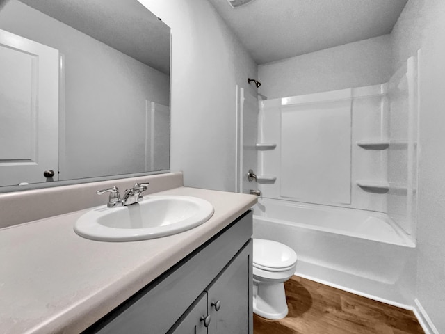 full bathroom featuring toilet, vanity, shower / bath combination, and wood-type flooring