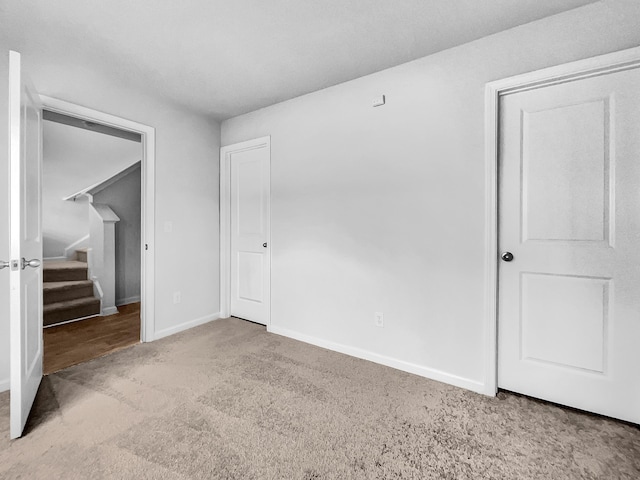 unfurnished bedroom featuring light carpet