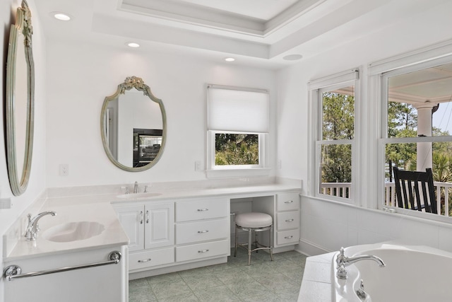 bathroom featuring tile flooring, double vanity, a tray ceiling, and a bathtub