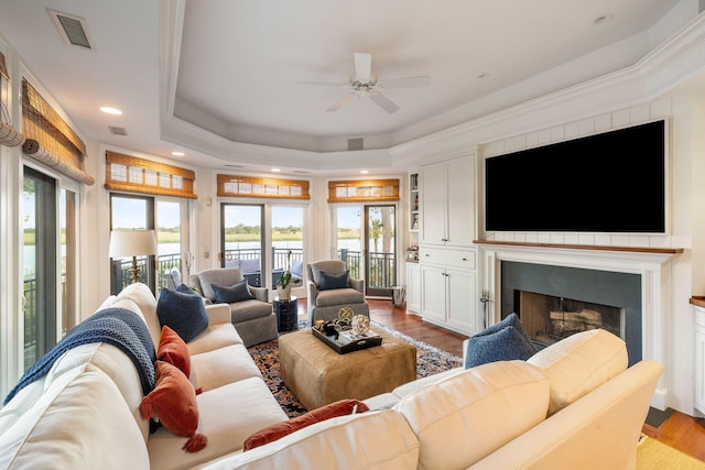 3121 Marshgate Dr, Seabrook Island, SC 29455 - living room featuring a tray ceiling, healthy amount of natural light, ceiling fan, a fireplace, and recessed lighting