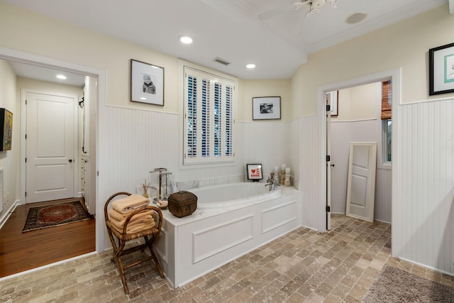 3121 Marshgate Dr, Seabrook Island, SC 29455 - full bath featuring wainscoting, a garden tub, brick flooring, a ceiling fan, and ornamental molding