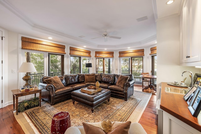 3121 Marshgate Dr, Seabrook Island, SC 29455 - living area featuring a tray ceiling, ceiling fan, wood-type flooring, recessed lighting, and crown molding
